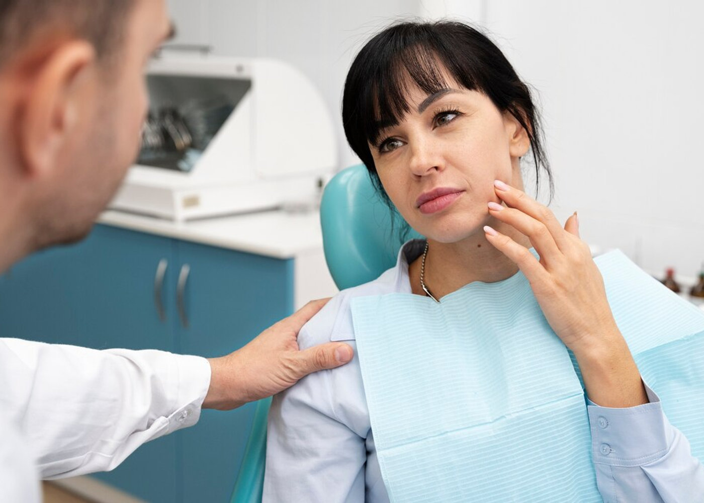 A dentist assessing a patient